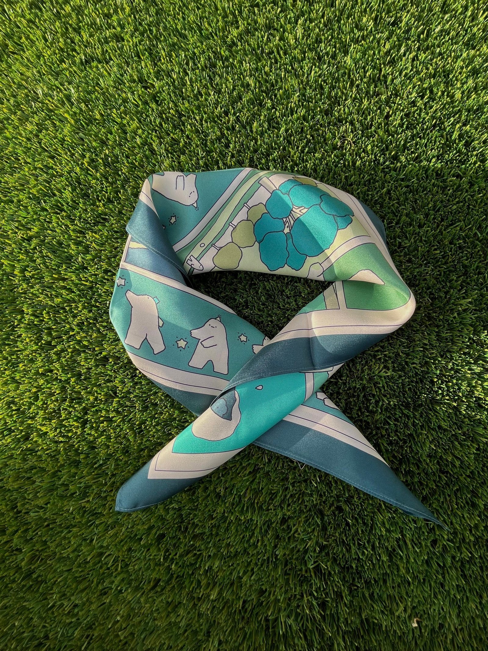 The mochi man patterned silk scarf knot on the grass