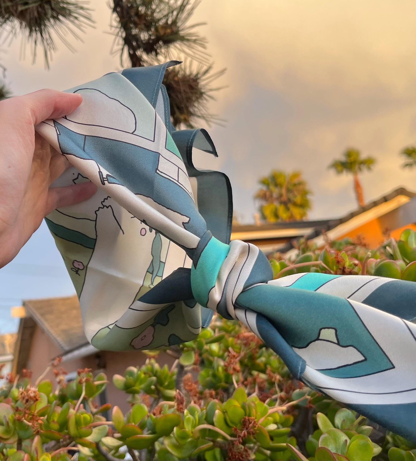 A silk scarf knot with the pattern of machi man fluttering in the wind